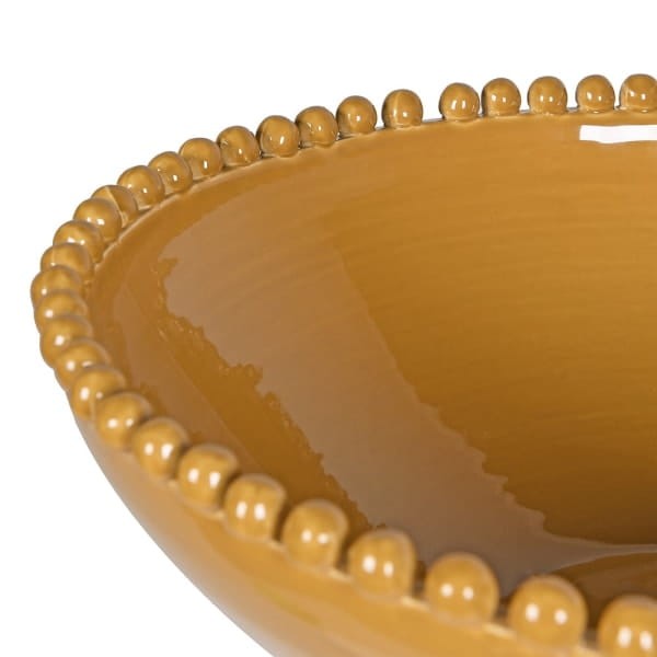 Zdobiona krawędź żółtej porcelanowej misy